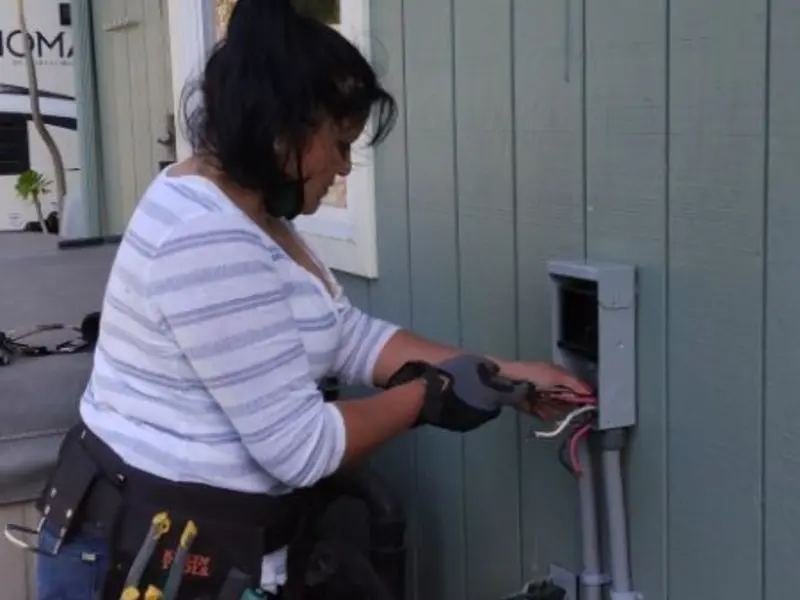 Licensed electrician wiring an exterior subpanel in Howard